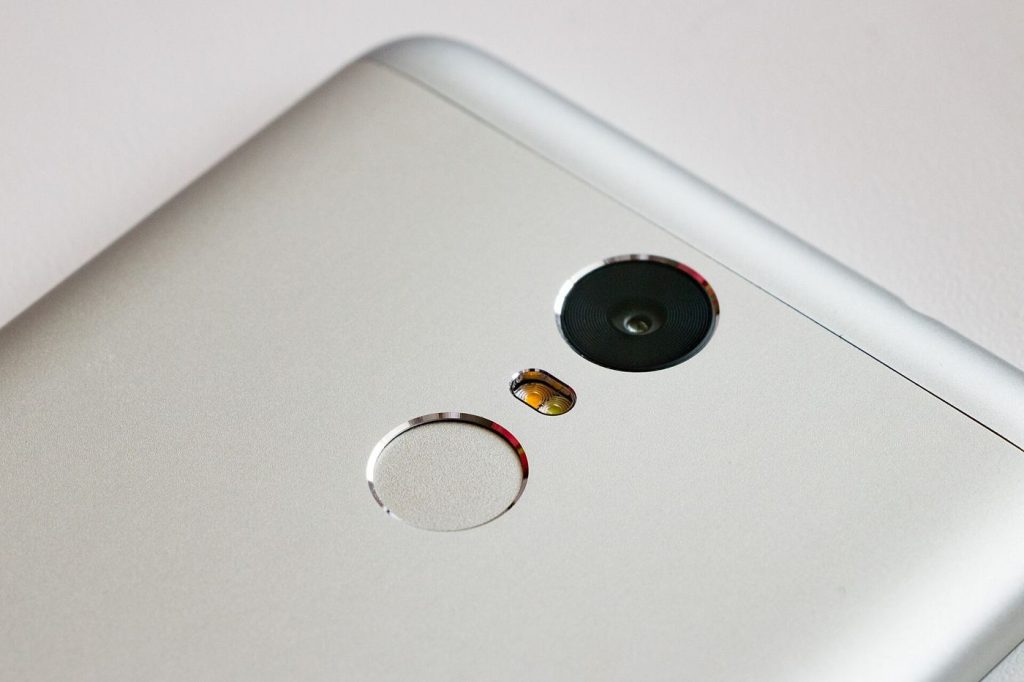 Passkeys Gain Ground as Apps Move Beyond Passwords user unlocking smartphone with fingerprint for secure login