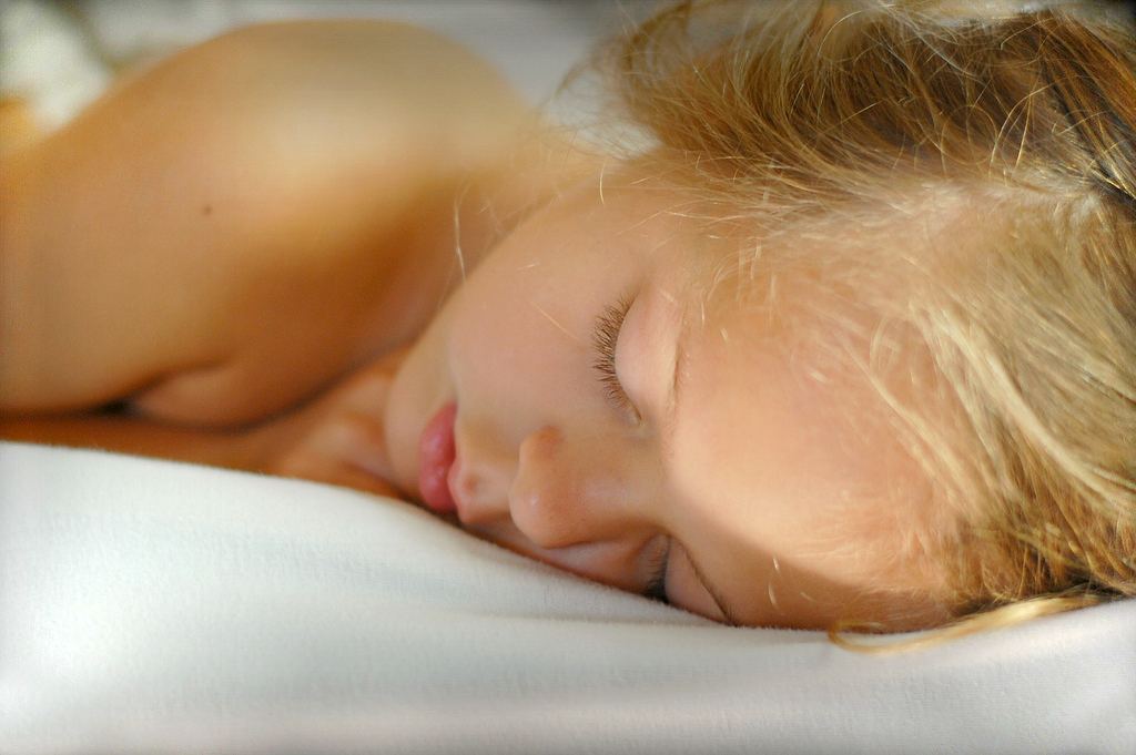 Regular Sleep Schedules Support Mood Focus and Wellbeing person sleeping peacefully in dark bedroom
